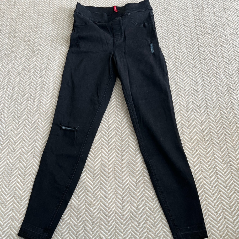 Spanx black skinny jeans with raw hem. Very flattering!